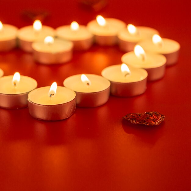 Small candles with heart on table 