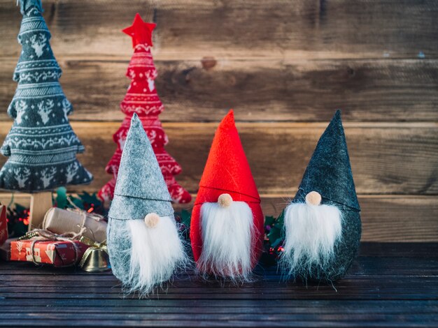 Small Christmas elves on wooden table 