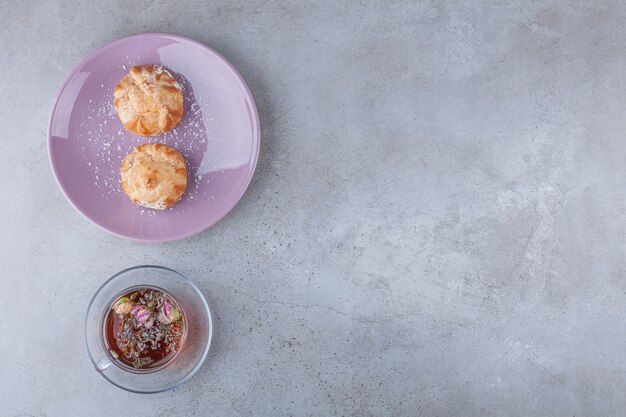 Small cookies profitroles with sugar powder and cinnamon sticks. 