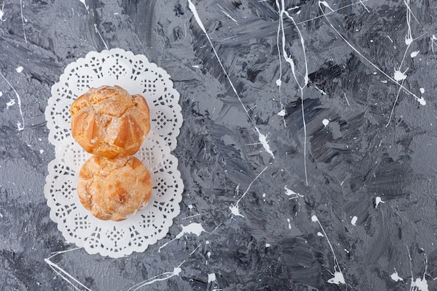 Small cookies profitroles with sugar powder . 