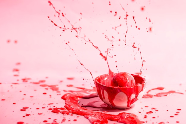 Small cup with red paint abstract background