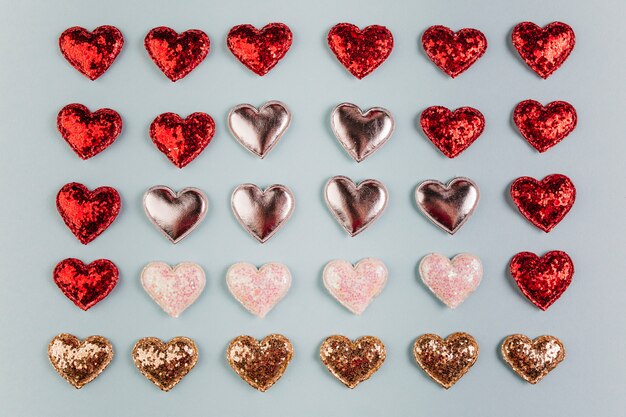 Small different shiny hearts on table