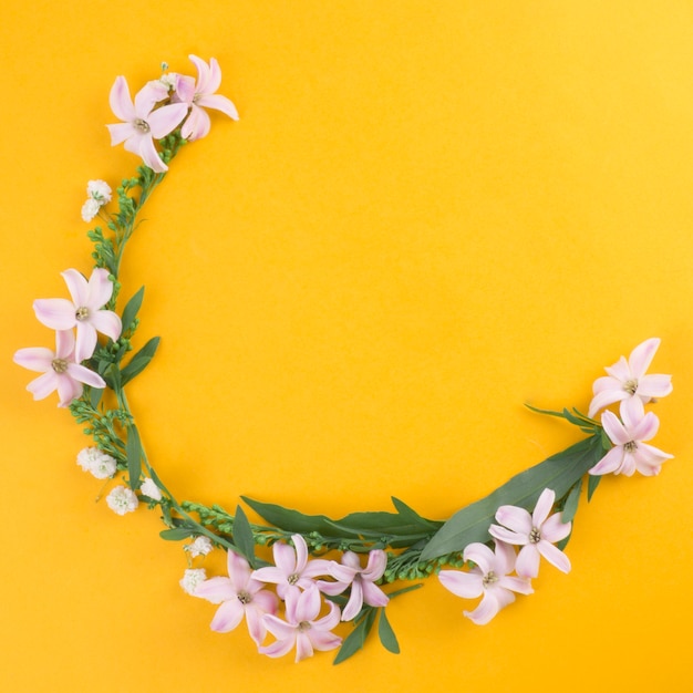 Small flowers with green leaves on table