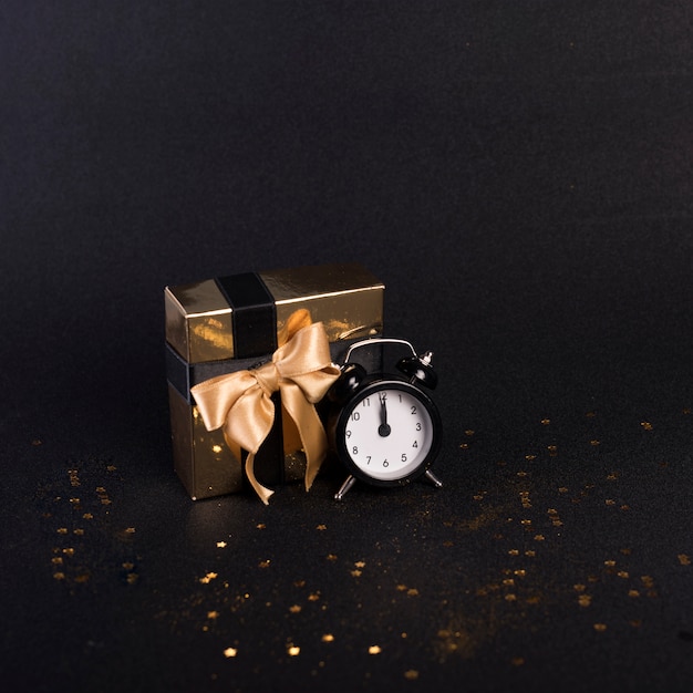 Small gift box with clock on table 