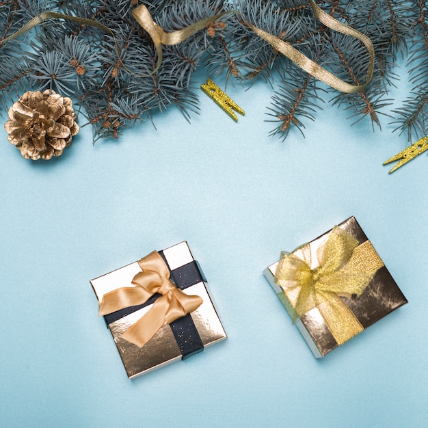 Small gift boxes with fir tree branches on table