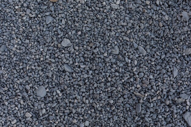 Small grey stones for construction on the ground