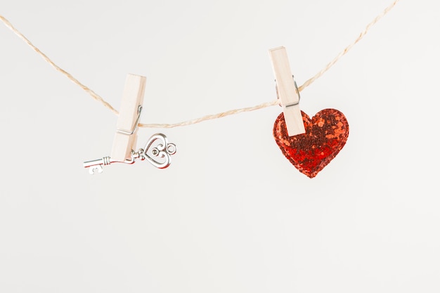 Free photo small heart with key hanging on rope