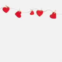 Free photo small hearts pinned to rope on table