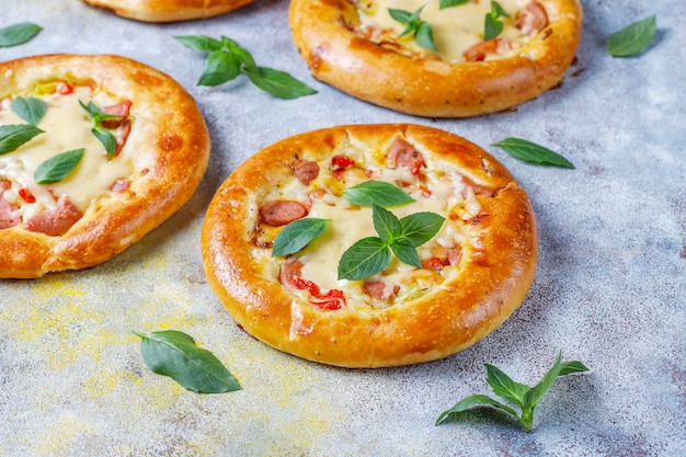 Small homemade pizzas fresh with basil.