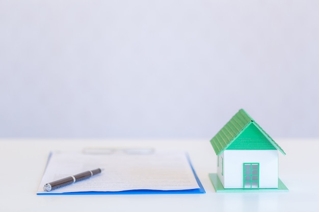 Small houses modern design and documents with pen on white 