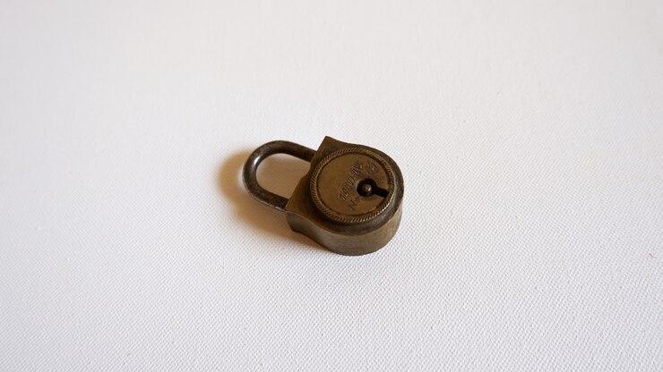 Free Photo small metallic lock placed on a white surface
