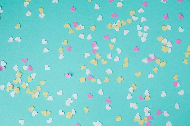 Small paper hearts scattered on table