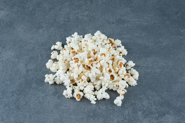 Small pile of toothsome popcorn on marble