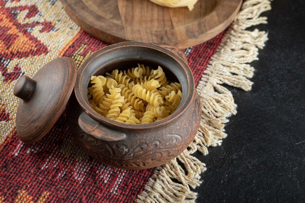 A small pot of unprepared spiral fresh macaroni
