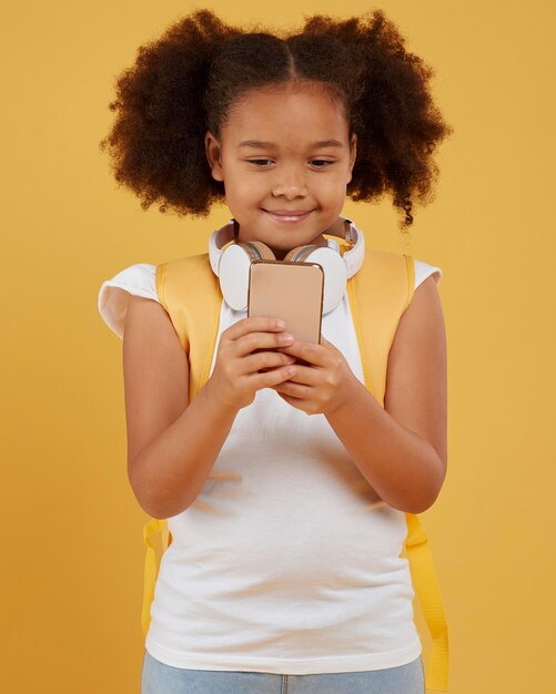 Small school girl using mobile phone