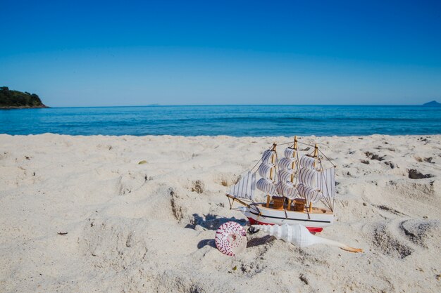 Small ship souvenir on sand