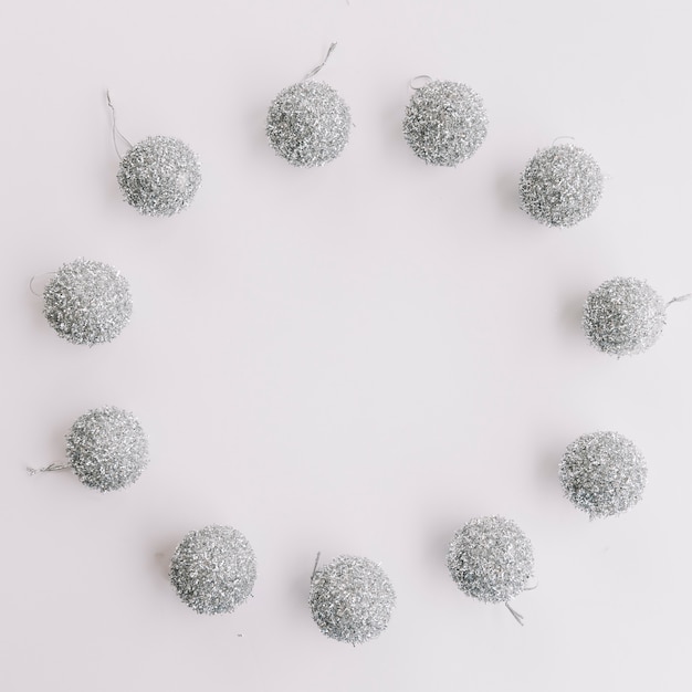 Small silver baubles on table