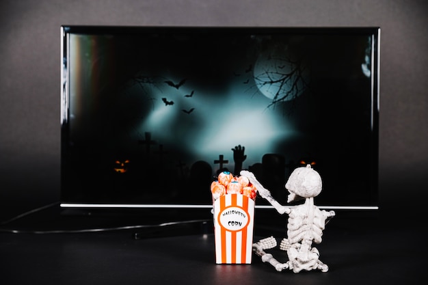 Small skeleton with popcorn and TV