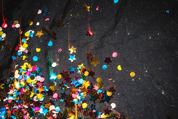 Small spangles scattered on black table