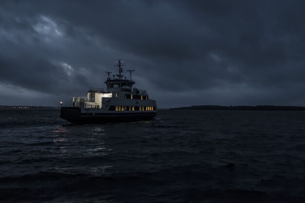 small touring boat sailing at the night