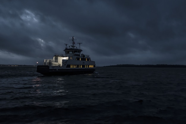 small touring boat sailing at the night