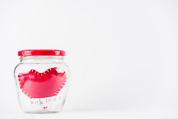 Small toy heart in glass can 