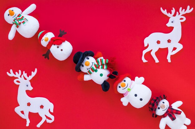 Small toy snowmen with deer on table