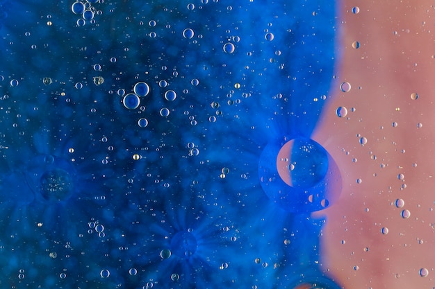 Small water drops over the blue backdrop