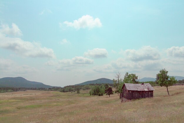 Small wooden barn built in a large field