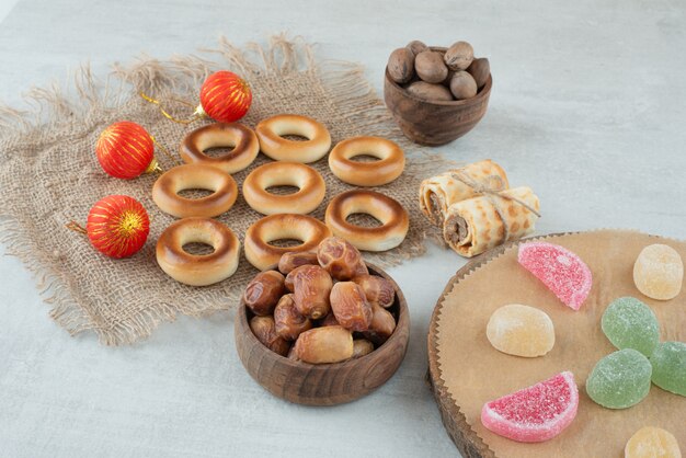 A small wooden bowl of dried fruits with jelly candies on white background. High quality photo