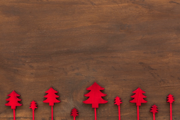 Small wooden Christmas trees on table 