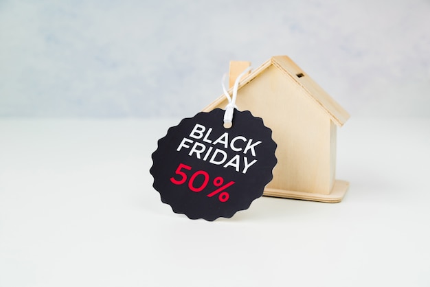 Small wooden house with black friday tag