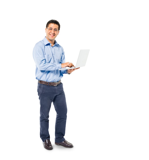 A Smart Casual Mans Standing while using his Laptop