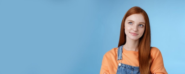 Smart creative pretty redhead female freelancer thoughtfully look upper left corner pondering