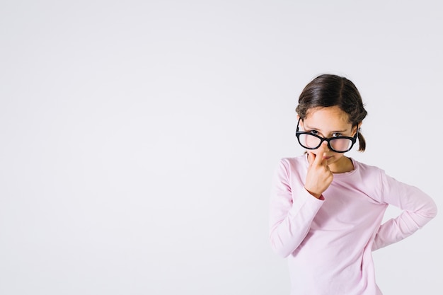 Smart girl adjusting glasses