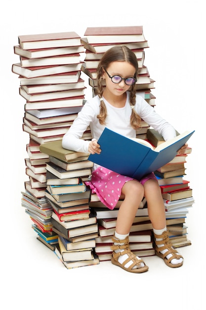 Smart girl sitting on many books