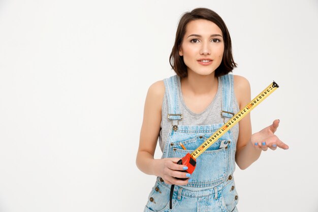 Smart happy woman builder, hold measuring tape