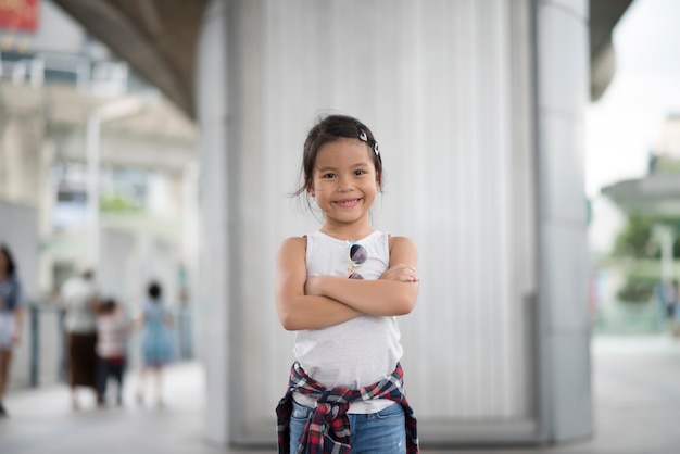 Smart little girl child standing in city