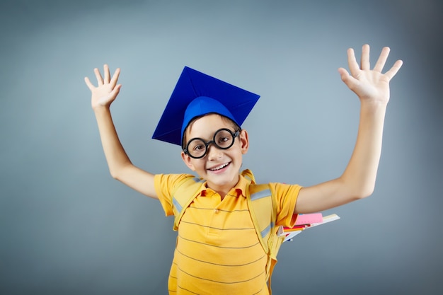 Free photo smart schoolboy having fun