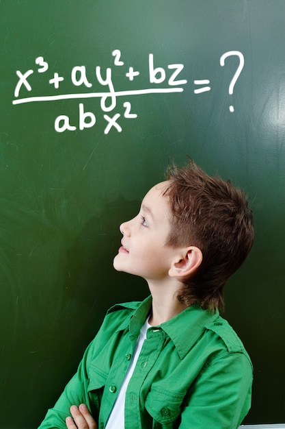 Free photo smart schoolboy thinking the answer