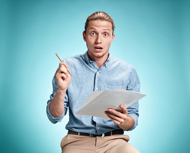 Smart surprised student with great idea holding sheets of paper