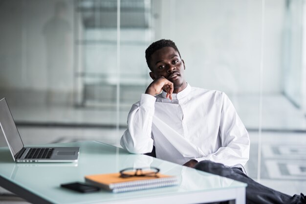 Smart young businessman looking at the computer in office