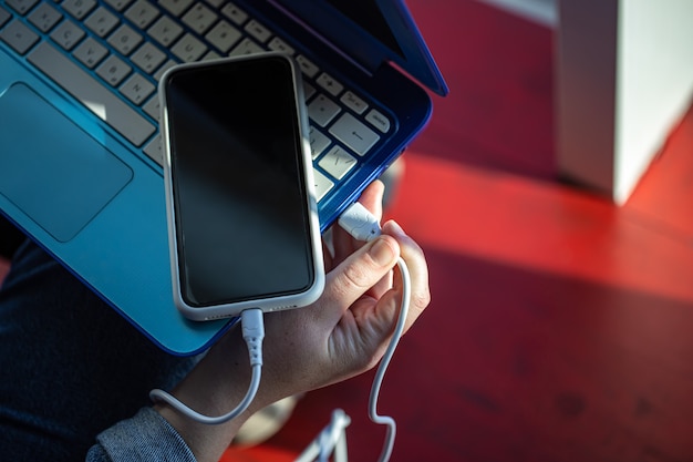 The smartphone is connected to the laptop via usb cable