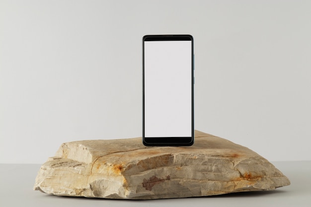 Free photo smartphone minimal display on rock