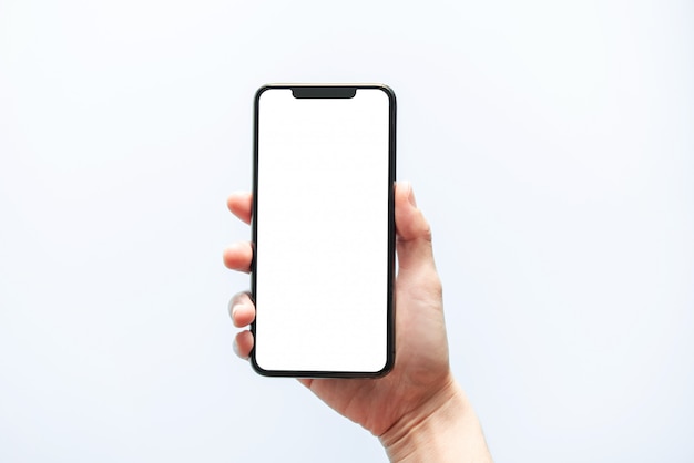 Smartphone mockup. close up hand holding black phone white screen. isolated on white background. mobile phone frameless design concept.