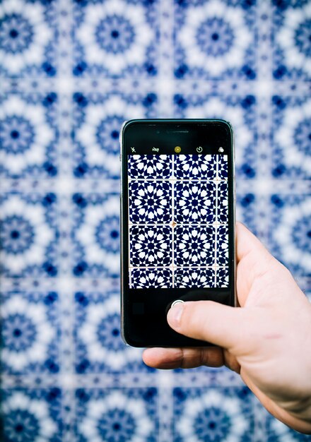 Smartphone taking photo of oriental pattern