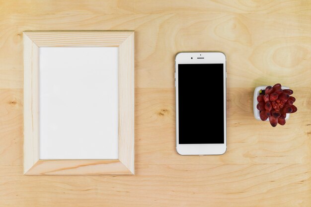 Smartphone with blank frame on table