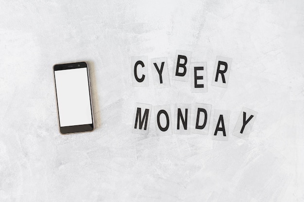 Smartphone con iscrizione cyber ​​monday sul tavolo