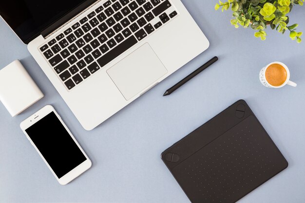 Smartphone with laptop, coffee cup and notebook 