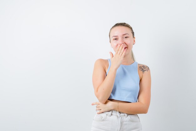 smiled girl is closing her mouth on white background